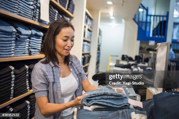 mid adult woman choosing clothes - guam premier outlets stock pictures, royalty-free photos & images