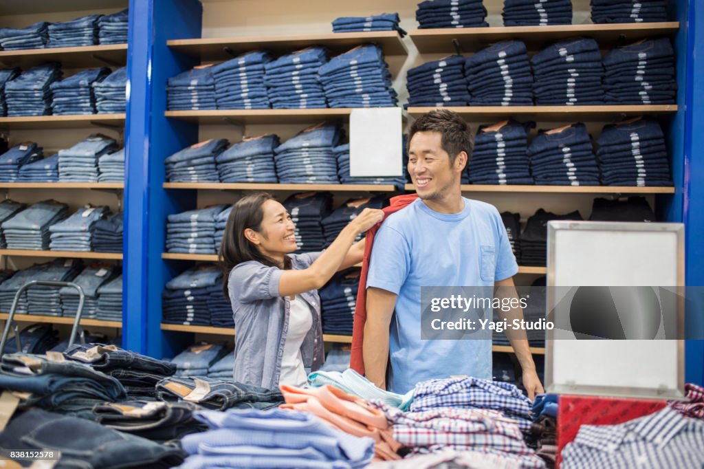 Mid adult couple choosing clothes