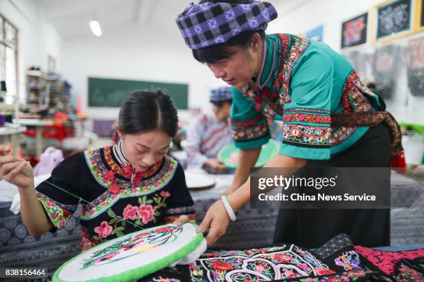 Chinese woman of Bouyei ethnic group makes embroidery at Wangmo County on August 24, 2017 in Qianxinan Bouyei and Miao Autonomous Prefecture, Guizhou...