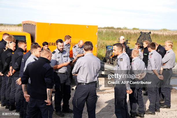 Members of the Danish Emergency Management Agency prepare to assist the police at Kalvebod Faelled near Copenhagen on August 24 in search of the...