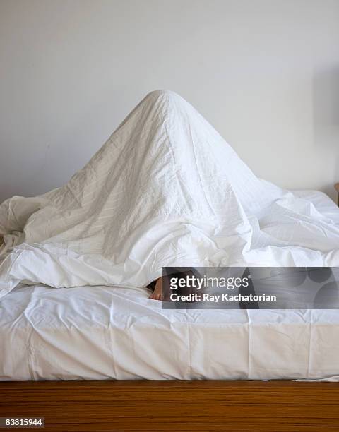 sheets over head vertical  - duvet stock pictures, royalty-free photos & images