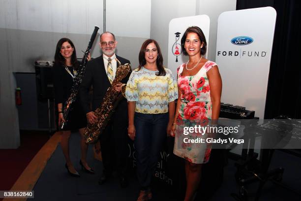 Nannette Velez , Jorge Jimenez , Vivian Davila and Becky Villaescusa pose on musical instruments donation display as part of Latin GRAMMY In The...