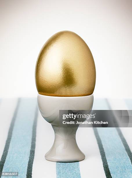 golden egg - eierbecher stock-fotos und bilder