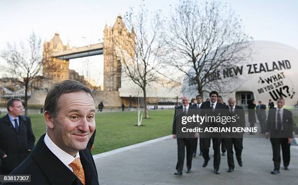 New Zealand's Prime Minister John Key prepares to bid farewell to All Blacks rugby union team players as they leave a giant inflatable rugby ball in...