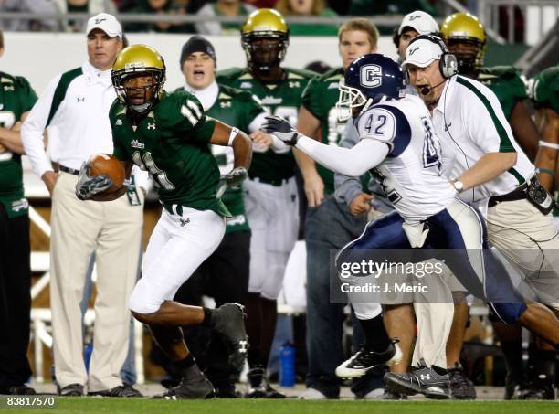 Receiver Marcus Edwards of the South Florida Bulls breaks the tackle of cornerback Robert McClain of the Connecticut Huskies during the game at...