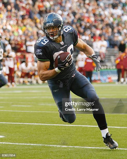 Tight end John Carlson of the Seattle Seahawks picks up yardage after the catch in the game between the Seahawks and the Redskins at Qwest Field in...
