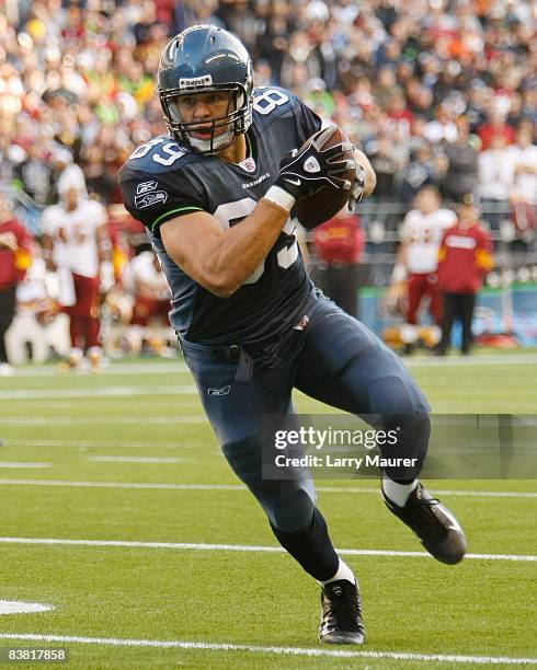 Tight end John Carlson of the Seattle Seahawks picks up yardage after the catch in the game between the Seahawks and the Redskins at Qwest Field in...