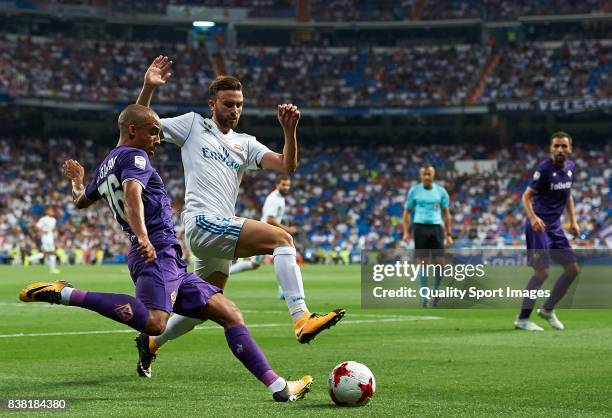 Borja Mayoral of Real Madrid competes for the ball with Bruno Gaspar of Fiorentina during the Trofeo Santiago Bernabeu match between Real Madrid and...