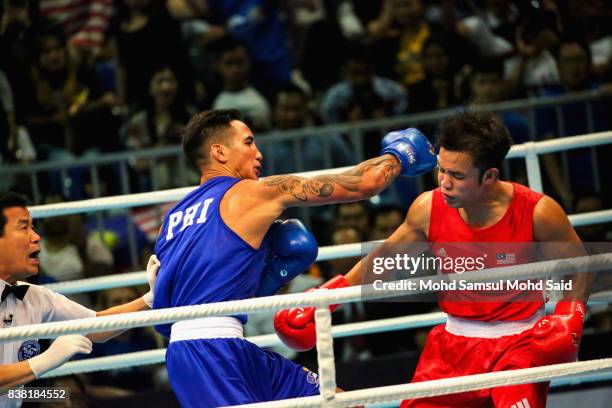 Gold medalist Marvin John Nobel Tupas of Philippines competes against Adli Hafidz Mohd Pauzi of Malaysia in the men's boxing ligh heavy at the 29th...