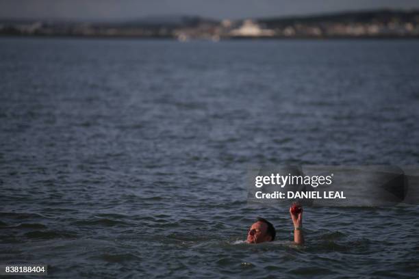 Cricket player retrieves the ball from the sea Cricket players from the Royal Southern Yacht Club and Cowes Island Sailing Club play an annual...