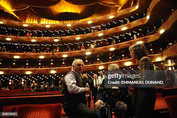 Renowned maestro Daniel Barenboim talks with violinist Itzhak Perlman and his wife Toby while taking a break in a dress rehearsal of Richard Wagner's...