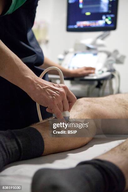 Radiology center, France, radiologist carries out a Doppler ultrasound on a patient with varicose veins.