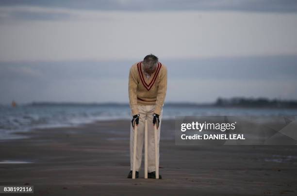 Cricket player sets up a wicket ahead of an annual cricket match contested between players from the Royal Southern Yacht Club and Cowes Island...