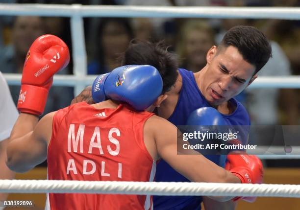 Marvin John Nobel Tupas of the Philippines fights against Adli Hafidz binti Mohamad Fauzi during the boxing light heavyweight final at the 29th...