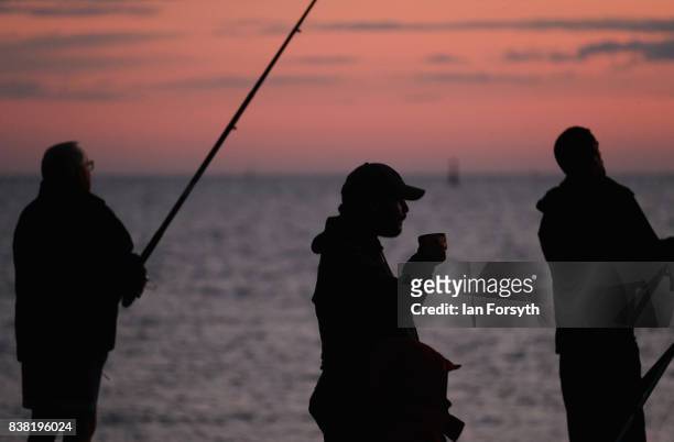 Fisherman has a drink of tea as he stands on the end of the breakwater at South Gare on August 24, 2017 in Redcar, England. The manmade breakwater at...