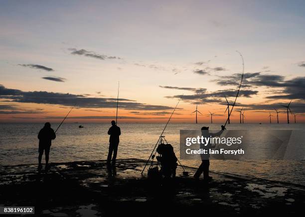 Fishermen stand on the end of the breakwater as they fish at South Gare on August 24, 2017 in Redcar, England. The manmade breakwater at South Gare...