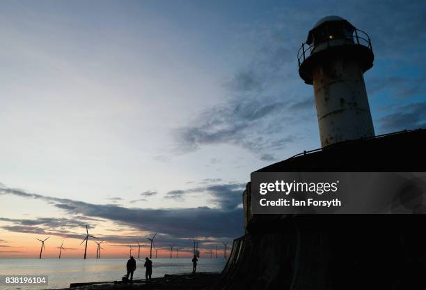 Fishermen stand on the end of the breakwater as they fish at South Gare on August 24, 2017 in Redcar, England. The manmade breakwater at South Gare...