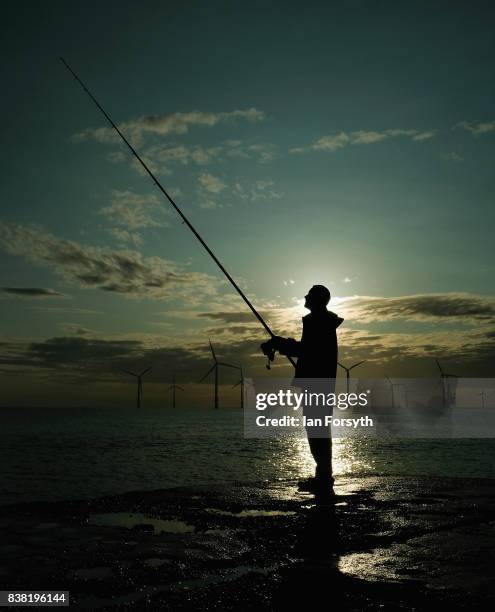 Fisherman stands on the end of the breakwater as he fishes at South Gare on August 24, 2017 in Redcar, England. The manmade breakwater at South Gare...