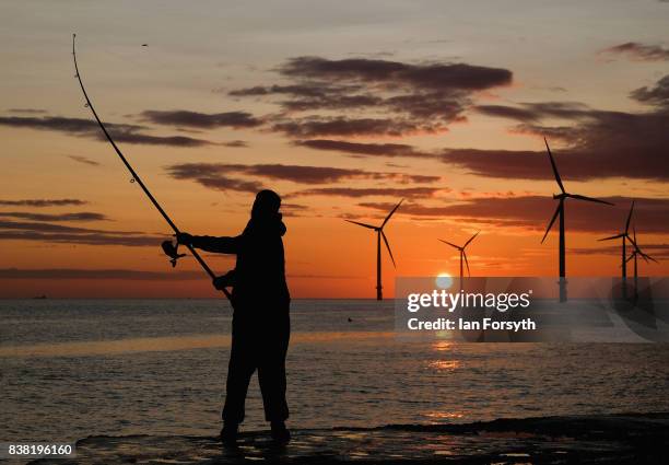 Fisherman casts from the end of the breakwater at South Gare on August 24, 2017 in Redcar, England. The manmade breakwater at South Gare helps...