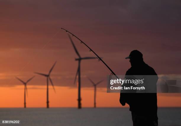 Fisherman stands on the end of the breakwater as he fishes at South Gare on August 24, 2017 in Redcar, England. The manmade breakwater at South Gare...