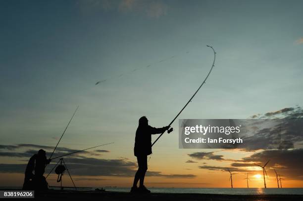 Fisherman casts from the end of the breakwater at South Gare on August 24, 2017 in Redcar, England. The manmade breakwater at South Gare helps...