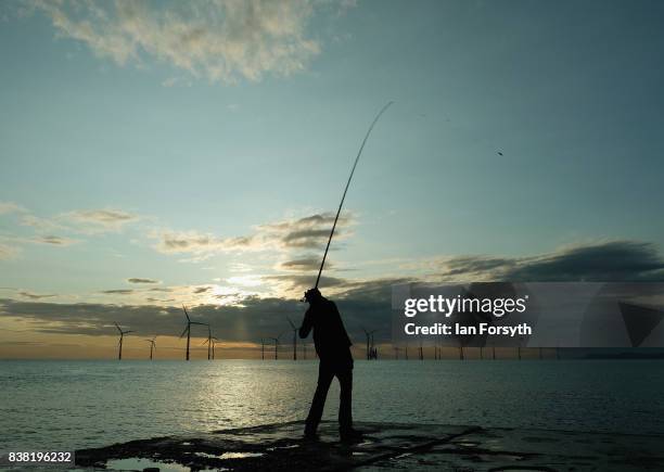 Fisherman casts from the end of the breakwater at South Gare on August 24, 2017 in Redcar, England. The manmade breakwater at South Gare helps...