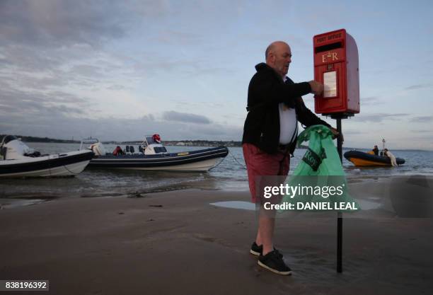 Arthur Reeder from the Isle of Wight Postal Museum sets up a temporary postbox on the Brambles Bank ahead of an annual cricket match contested...