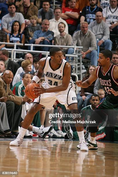 Miles of the Utah Jazz moves the ball against Charlie Bell of the Milwaukee Bucks during the game on November 19, 2008 at EnergySolutions Arena in...