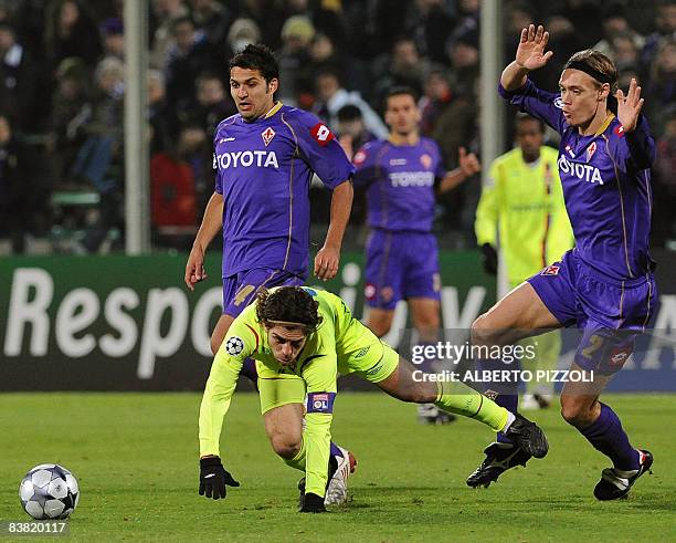 Lyon's Brazilian midfielder Pernambucano Juninho is takled by Fiorentina's Danish defender Per Billeskov Kroeldrup during their Champions League...