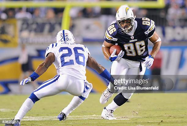 Brandon Manumaleuna of the San Diego Chargers carries the ball against Kelvin Hayden of the Indianapolis Colts at Qualcomm Stadium on November 23,...