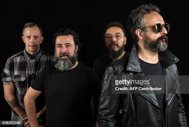 Randy Ebright, Micky Huidobro, Paco Ayala and Tito Fuentes, members of the Mexican rock band Molotov, pose during a photo shoot in Mexico City on...