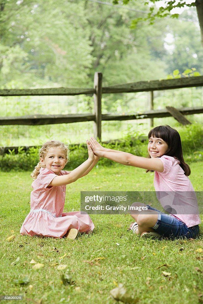 Young Girls Playing in the Grass