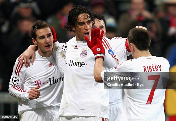 Miroslav Klose of Bayern is celebrated by his team mates Luca Toni and Franck Ribery after scoring the 3:0 goal during the UEFA Champions League...