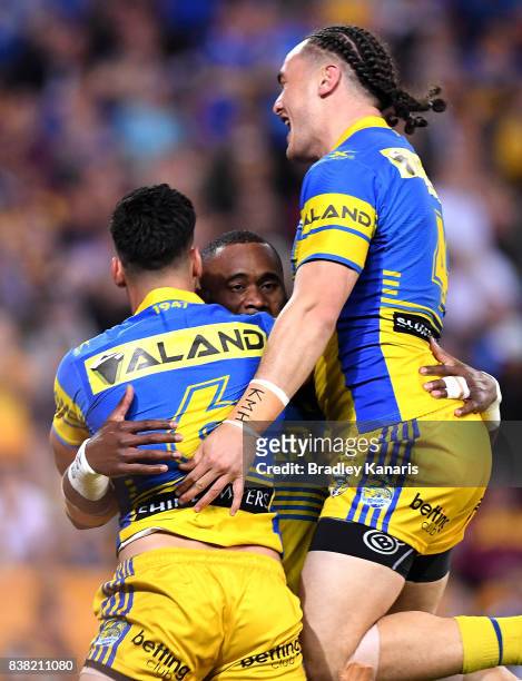 Semi Radradra of the Eels celebrates with team mates after scoring a try during the round 25 NRL match between the Brisbane Broncos and the...