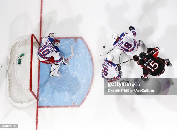 Stephen Valiquette, Dan Girardi and Marc Staal of the New York Rangers defend the net against Dany Heatley of the Ottawa Senators on November 22,...