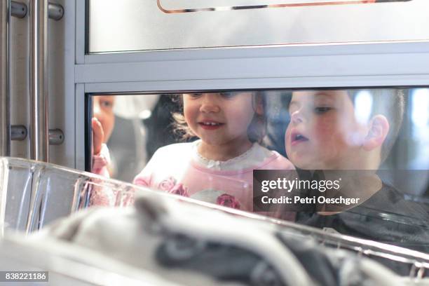 a young boy and girl meet their new baby brother for the first time. - sibling hospital stock pictures, royalty-free photos & images