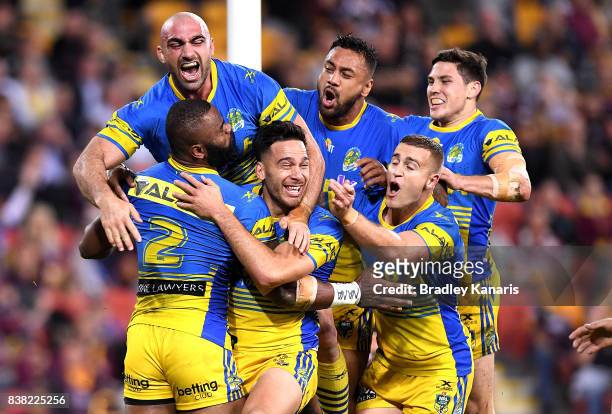 Semi Radradra of the Eels is congratulated by team mates after scoring a try during the round 25 NRL match between the Brisbane Broncos and the...