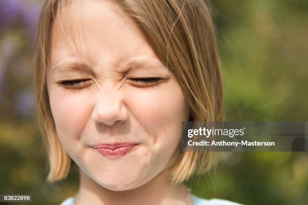 young girl making sour face - sour taste stock pictures, royalty-free photos & images