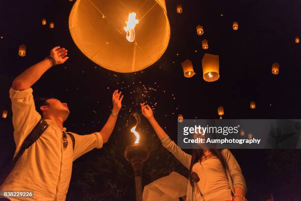 the chinese foreign tourists  made lantern in yi peng festival, chiangmai, thailand. - yi peng stock pictures, royalty-free photos & images