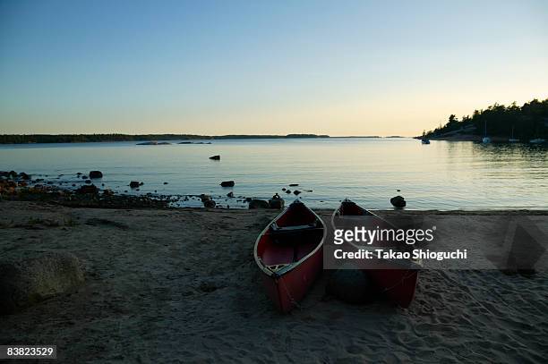 canoes sitting by the lake - parry sound stock pictures, royalty-free photos & images