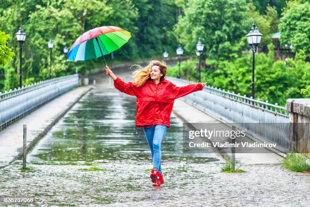 beautiful girl with umbrella dancing in the rain - girl shower stock pictures, royalty-free photos & images