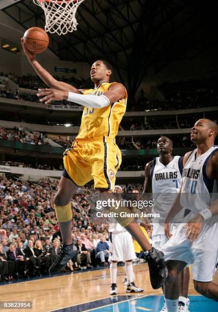 Danny Granger of the Indiana Pacers goes in for the layup against Devean George of the Dallas Mavericks on November 25, 2008 at the American Airlines...