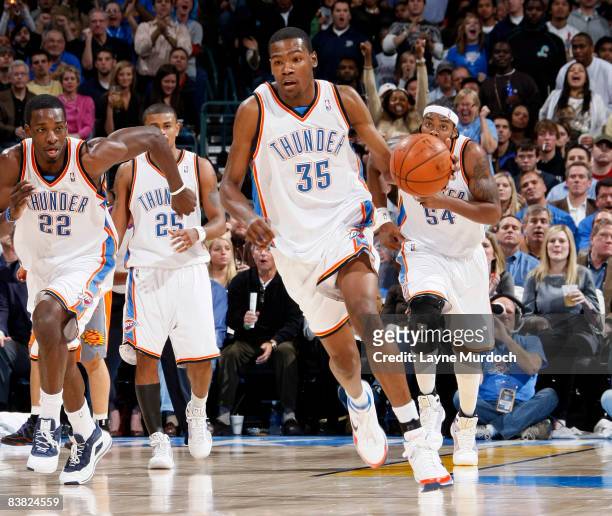 Kevin Durant of the Oklahoma City Thunder leads his teammates Jeff Green, Earl Watson, and Chris Wilcox up the court during a game against the...