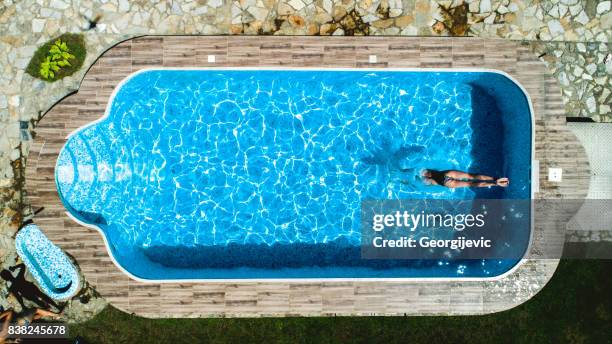 jumpping into the pool - swimming pool top view stock pictures, royalty-free photos & images