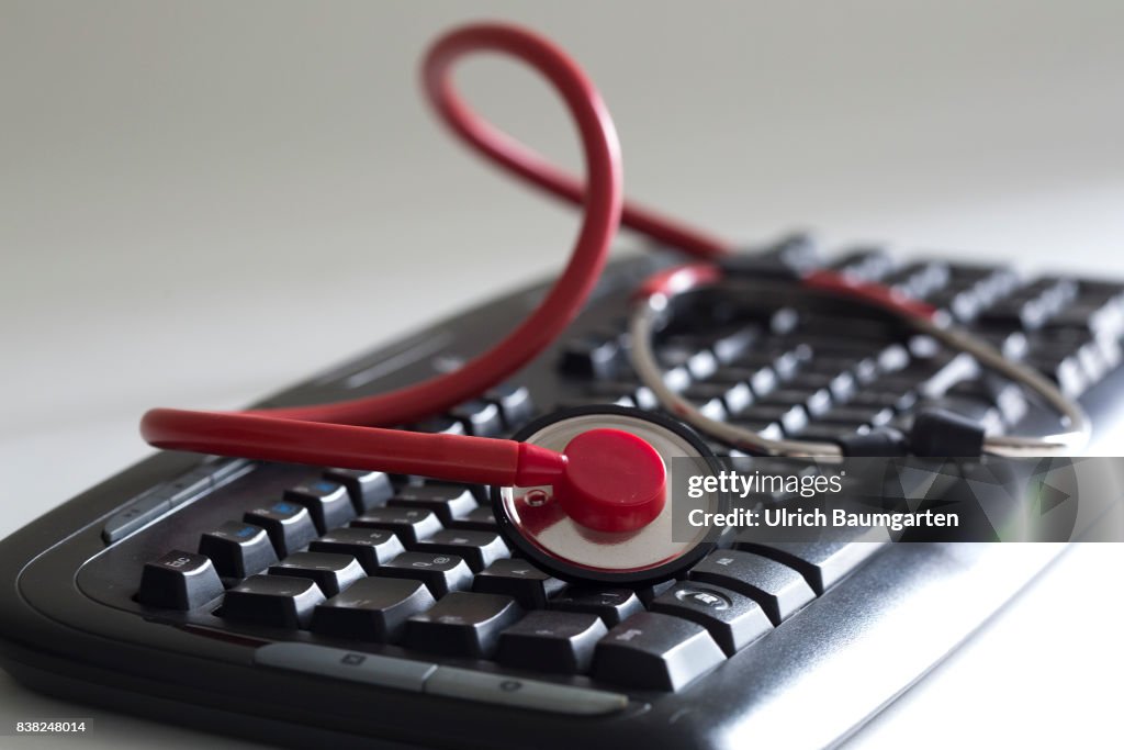 Computer crime - computer keyboard and a stethoscope.