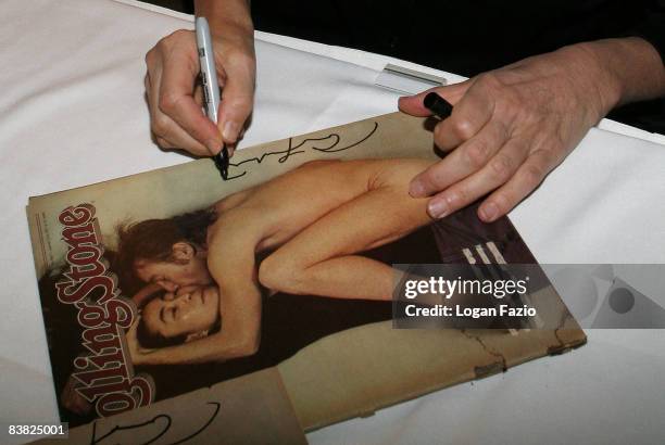 Photographer Annie Leibovitz autographs her iconic Rolling Stone cover photo featuring John Lennon and Yoko Ono at The Biltmore Country Club Ballroom...