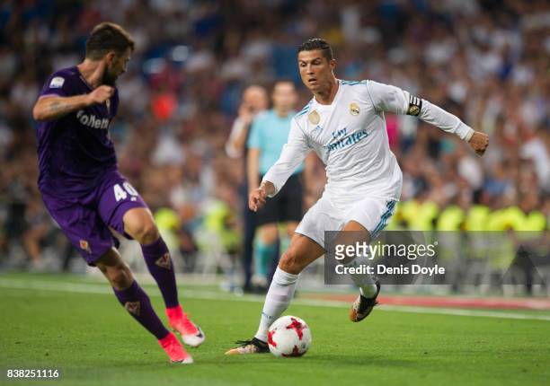 Cristiano Ronaldo of Real Madrid CF takes on Nenad Tomovic of ACF Fiorentin during the Santiago Bernabeu Trophy match between Real Madrid CF and ACF...