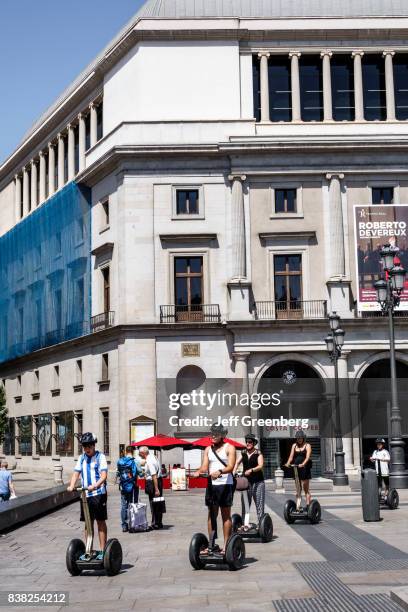 People riding Segway's outside the Teatro Real, Royal Theatre.