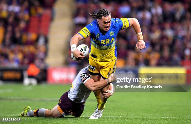 Brad Takairangi of the Eels is tackled during the round 25 NRL match between the Brisbane Broncos and the Parramatta Eels at Suncorp Stadium on...