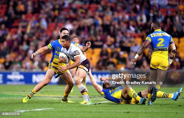 David Mead of the Broncos is caught by the defence during the round 25 NRL match between the Brisbane Broncos and the Parramatta Eels at Suncorp...